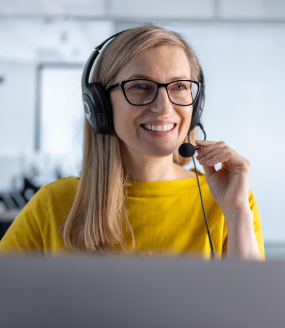 Customer support agent wearing a headset assisting a client, representing logistics support services in Australia.