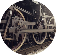 Close-up of train wheels on railway tracks used for container transport.